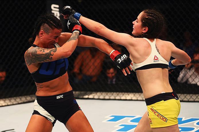 HAMBURG, GERMANY - SEPTEMBER 03: Veronica Macedo (R) of Venezuela punches Ashlee Evans-Smith (L) of the USA compete in their Womens Bantamweight Bout during the UFC Fight Night held at Barclaycard Arena on September 3, 2016 in Hamburg, Germany. (Photo b