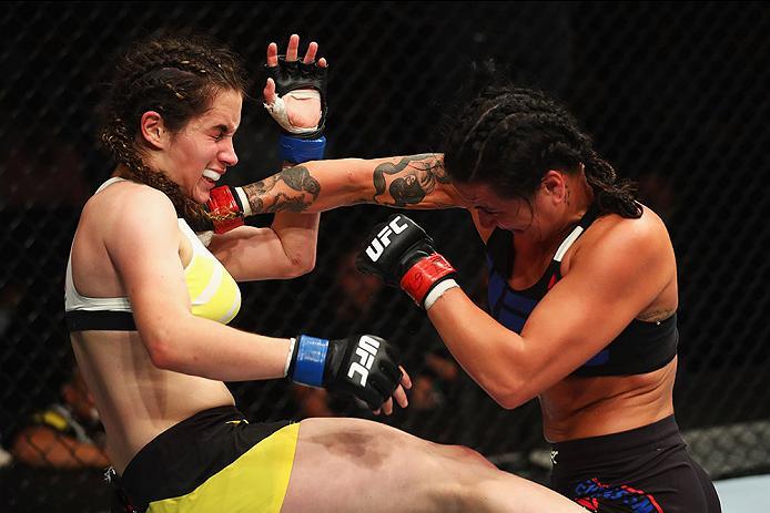 HAMBURG, GERMANY - SEPTEMBER 03: Ashlee Evans-Smith (R) of the USA punches Veronica Macedo (L) of Venezuela in their Womens Bantamweight Bout during the UFC Fight Night held at Barclaycard Arena on September 3, 2016 in Hamburg, Germany. (Photo by Dean M