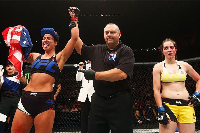 HAMBURG, GERMANY - SEPTEMBER 03: Ashlee Evans-Smith (L) of the USA celebrates his knockout victory over Veronica Macedo (R) of Venezuela in their Womens Bantamweight Bout during the UFC Fight Night held at Barclaycard Arena on September 3, 2016 in Hambur