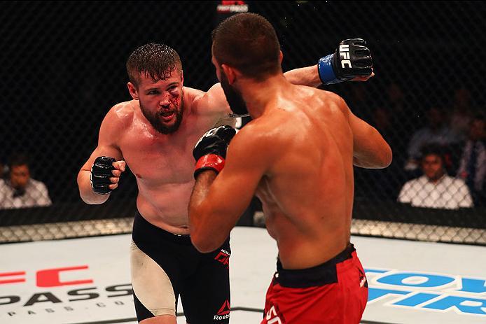 HAMBURG, GERMANY - SEPTEMBER 03: Nicolas Dalby (L) of Denmark punches Peter Sobotta (R) of Poland and Germany compete in their Welterweight Bout during the UFC Fight Night held at Barclaycard Arena on September 3, 2016 in Hamburg, Germany. (Photo by Dea