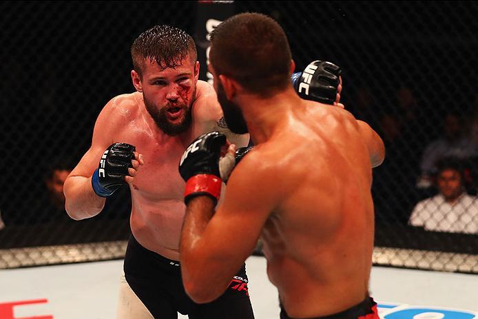 HAMBURG, GERMANY - SEPTEMBER 03: Nicolas Dalby (L) of Denmark punches Peter Sobotta (R) of Poland and Germany compete in their Welterweight Bout during the UFC Fight Night held at Barclaycard Arena on September 3, 2016 in Hamburg, Germany. (Photo by Dea