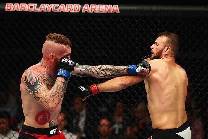 HAMBURG, GERMANY - SEPTEMBER 03: Jim Wallhead (L) of England punches Jessin Ayari (R) of Germany compete in their Welterweight Bout during the UFC Fight Night held at Barclaycard Arena on September 3, 2016 in Hamburg, Germany. (Photo by Dean Mouhtaropou