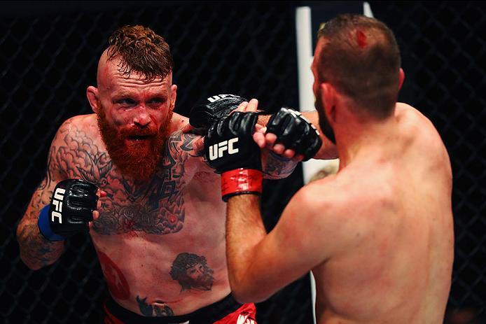 HAMBURG, GERMANY - SEPTEMBER 03: Jim Wallhead (L) of England punches Jessin Ayari (R) of Germany compete in their Welterweight Bout during the UFC Fight Night held at Barclaycard Arena on September 3, 2016 in Hamburg, Germany. (Photo by Dean Mouhtaropou