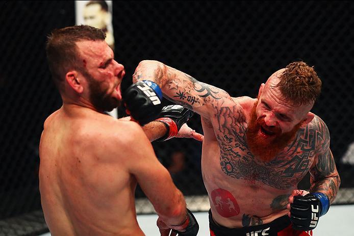 HAMBURG, GERMANY - SEPTEMBER 03: Jim Wallhead (R) of England punches Jessin Ayari(L) of Germany compete in their Welterweight Bout during the UFC Fight Night held at Barclaycard Arena on September 3, 2016 in Hamburg, Germany. (Photo by Dean Mouhtaropoul