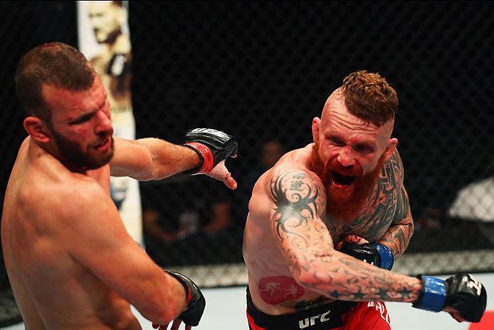 HAMBURG, GERMANY - SEPTEMBER 03: Jim Wallhead (R) of England punches Jessin Ayari(L) of Germany compete in their Welterweight Bout during the UFC Fight Night held at Barclaycard Arena on September 3, 2016 in Hamburg, Germany. (Photo by Dean Mouhtaropoul