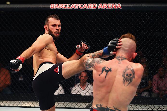 HAMBURG, GERMANY - SEPTEMBER 03: Jessin Ayari (L) of Germany kicks facing Jim Wallhead (R) of England and compete in their Welterweight Bout during the UFC Fight Night held at Barclaycard Arena on September 3, 2016 in Hamburg, Germany. (Photo by Dean Mo