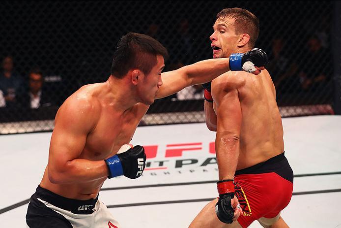 HAMBURG, GERMANY - SEPTEMBER 03: Tae Hyun Bang (L) of South Korea punches Nick Hein (R) of Germany compete in their Lightweight Bout during the UFC Fight Night held at Barclaycard Arena on September 3, 2016 in Hamburg, Germany. (Photo by Dean Mouhtaropo