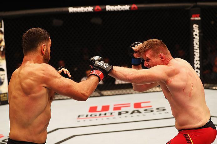 HAMBURG, GERMANY - SEPTEMBER 03: Josh Barnett (R) of USA punches Andrei Arlovski (L) of Belarus compete in their Heavyweight Bout during the UFC Fight Night held at Barclaycard Arena at Barclaycard Arena on September 3, 2016 in Hamburg, Germany. (Photo
