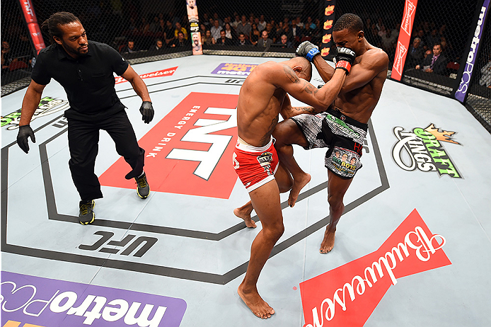 HOLLYWOOD, FL - JUNE 27: (R-L) Joe Merritt lands a knee to the body of Alex Oliveira of Brazil in their welterweight during the UFC Fight Night event at the Hard Rock Live on June 27, 2015 in Hollywood, Florida. (Photo by Josh Hedges/Zuffa LLC/Zuffa LLC