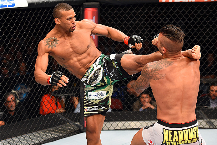 HOLLYWOOD, FL - JUNE 27: (L-R) Thiago Santos of Brazil lands a kick to the head of Steve Bosse of Canada in their middleweight during the UFC Fight Night event at the Hard Rock Live on June 27, 2015 in Hollywood, Florida. (Photo by Josh Hedges/Zuffa LLC