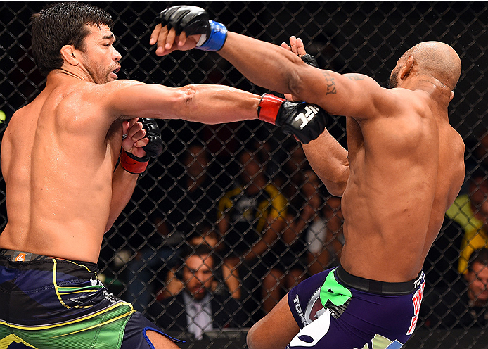 HOLLYWOOD, FL - JUNE 27: (L-R) Lyoto Machida punches Yoel Romero in their middleweight during the UFC Fight Night event at the Hard Rock Live on June 27, 2015 in Hollywood, Florida. (Photo by Josh Hedges/Zuffa LLC/Zuffa LLC via Getty Images)