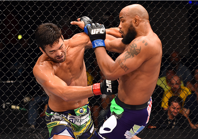 HOLLYWOOD, FL - JUNE 27: (L-R) Lyoto Machida punches Yoel Romero in their middleweight during the UFC Fight Night event at the Hard Rock Live on June 27, 2015 in Hollywood, Florida. (Photo by Josh Hedges/Zuffa LLC/Zuffa LLC via Getty Images)