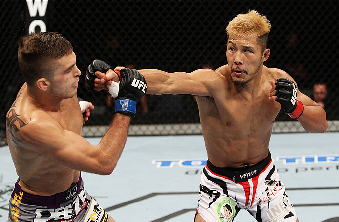 SAITAMA, JAPAN - SEPTEMBER 20: Kazuki Tokudome throws a punch on Johnny Case in their lightweight bout during the UFC Fight Night event inside the Saitama Arena on September 20, 2014 in Saitama, Japan. (Photo by Mitch Viquez/Zuffa LLC/Zuffa LLC via Getty
