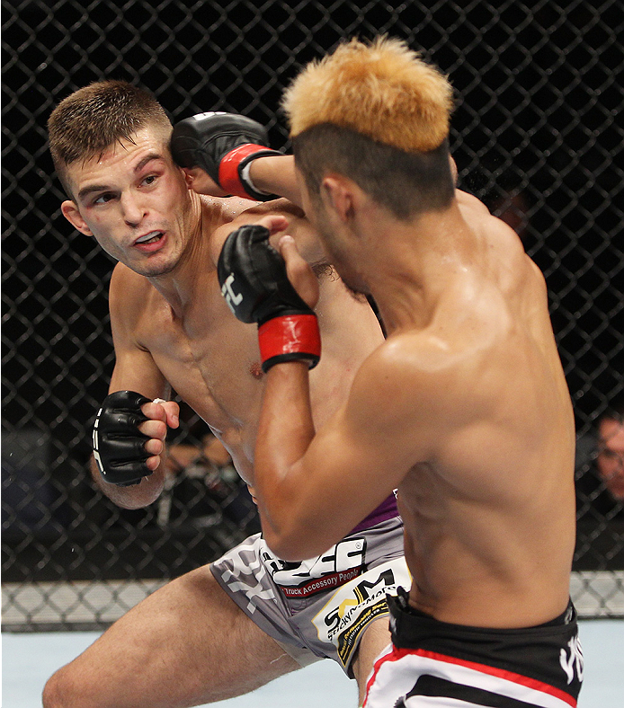 SAITAMA, JAPAN - SEPTEMBER 20: Kazuki Tokudome lands a punch on Johnny Case in their lightweight bout during the UFC Fight Night event inside the Saitama Arena on September 20, 2014 in Saitama, Japan. (Photo by Mitch Viquez/Zuffa LLC/Zuffa LLC via Getty I