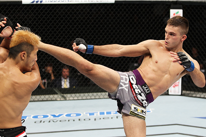 SAITAMA, JAPAN - SEPTEMBER 20: Johnny Case goes for a kick on Kazuki Tokudome in their lightweight bout during the UFC Fight Night event inside the Saitama Arena on September 20, 2014 in Saitama, Japan. (Photo by Mitch Viquez/Zuffa LLC/Zuffa LLC via Getty
