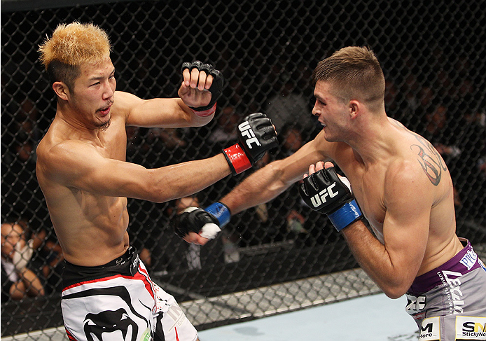 SAITAMA, JAPAN - SEPTEMBER 20: (L to R) Kazuki Tokudome loses his footing after being hit by Johnny Case in their lightweight bout during the UFC Fight Night event inside the Saitama Arena on September 20, 2014 in Saitama, Japan. (Photo by Mitch Viquez/Zu