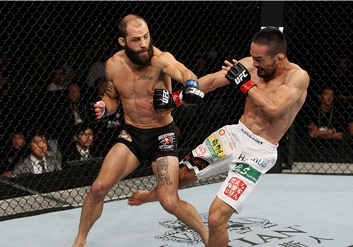 SAITAMA, JAPAN - SEPTEMBER 20: Katsunori Kikuno lands a low kick on Sam Sicilia in their featherweight bout during the UFC Fight Night event inside the Saitama Arena on September 20, 2014 in Saitama, Japan. (Photo by Mitch Viquez/Zuffa LLC/Zuffa LLC via G