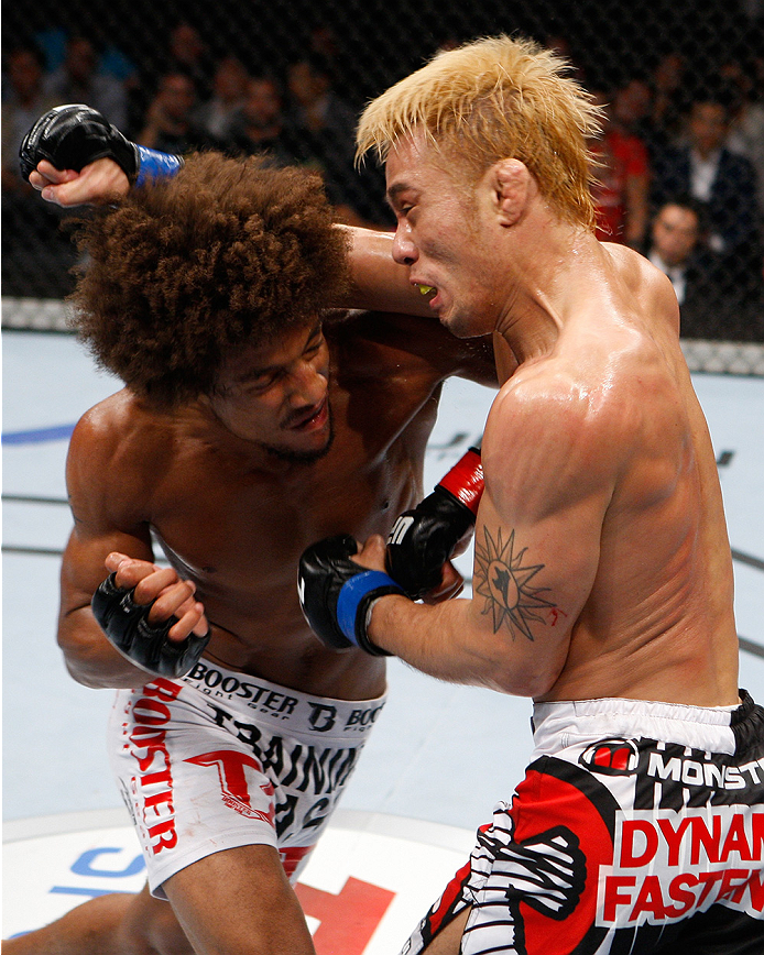 SAITAMA, JAPAN - SEPTEMBER 20: Alex Caceres and Masanori Kanehara exchange a fury of punches in their bantamweight bout during the UFC Fight Night event inside the Saitama Arena on September 20, 2014 in Saitama, Japan. (Photo by Mitch Viquez/Zuffa LLC/Zu