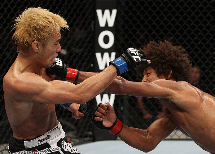 SAITAMA, JAPAN - SEPTEMBER 20: Alex Caceres throws a punch at Masanori Kanehara in their bantamweight bout during the UFC Fight Night event inside the Saitama Arena on September 20, 2014 in Saitama, Japan. (Photo by Mitch Viquez/Zuffa LLC/Zuffa LLC via Ge