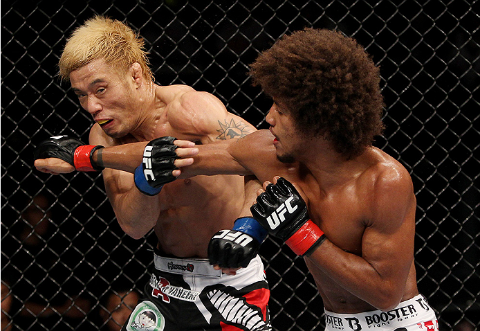 SAITAMA, JAPAN - SEPTEMBER 20: Alex Caceres throws a punch at Masanori Kanehara in their bantamweight bout during the UFC Fight Night event inside the Saitama Arena on September 20, 2014 in Saitama, Japan. (Photo by Mitch Viquez/Zuffa LLC/Zuffa LLC via Ge