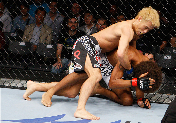 SAITAMA, JAPAN - SEPTEMBER 20: Masanori Kanehara lands punches on Alex Caceres in their bantamweight bout during the UFC Fight Night event inside the Saitama Arena on September 20, 2014 in Saitama, Japan. (Photo by Mitch Viquez/Zuffa LLC/Zuffa LLC via Ge