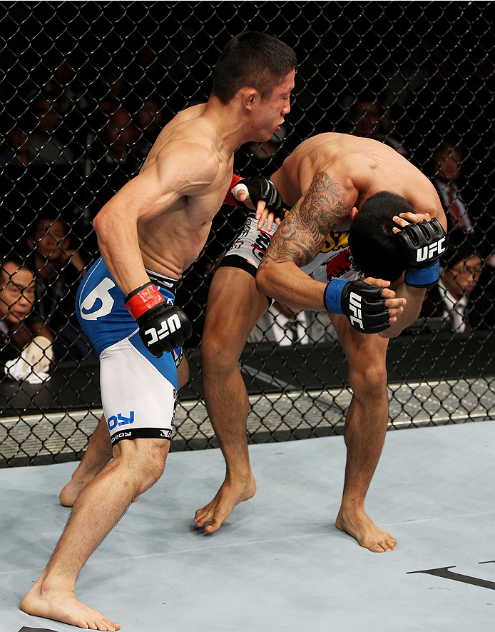 SAITAMA, JAPAN - SEPTEMBER 20: Kyoji Horiguchi lays down a number of punches on Jon Delos Reyes in their flyweight bout during the UFC Fight Night event inside the Saitama Arena on September 20, 2014 in Saitama, Japan. (Photo by Mitch Viquez/Zuffa LLC/Zu