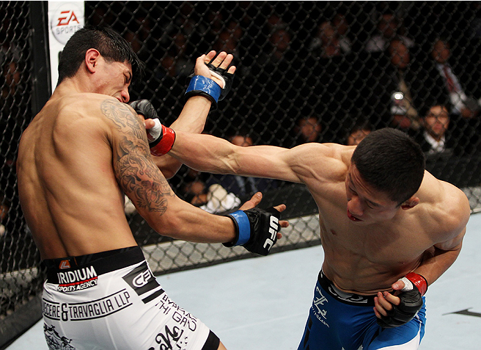 SAITAMA, JAPAN - SEPTEMBER 20: Kyoji Horiguchi punches Jon Delos Reyes in their flyweight bout during the UFC Fight Night event inside the Saitama Arena on September 20, 2014 in Saitama, Japan. (Photo by Mitch Viquez/Zuffa LLC/Zuffa LLC via Getty Images)