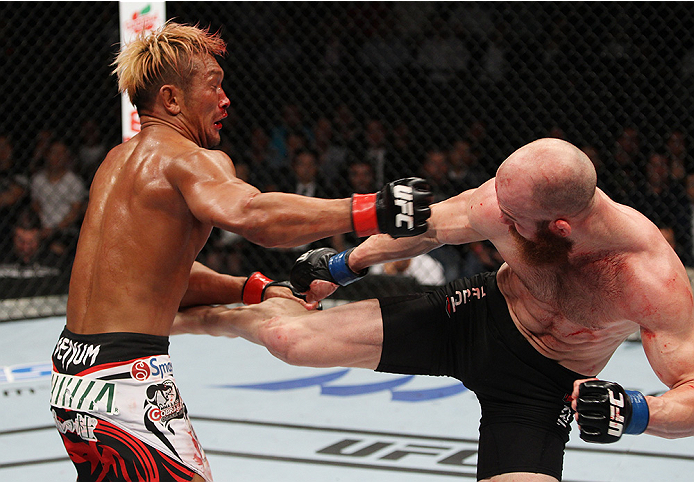 SAITAMA, JAPAN - SEPTEMBER 20: Richard Walsh kicks Kiichi Kunimoto in their welterweight bout during the UFC Fight Night event inside the Saitama Arena on September 20, 2014 in Saitama, Japan. (Photo by Mitch Viquez/Zuffa LLC/Zuffa LLC via Getty Images)