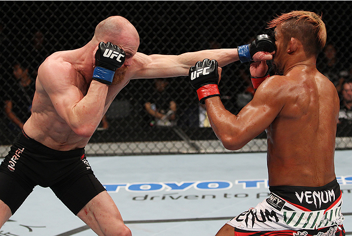 SAITAMA, JAPAN - SEPTEMBER 20: Richard Walsh lands a punch on Kiichi Kunimoto in their welterweight bout during the UFC Fight Night event inside the Saitama Arena on September 20, 2014 in Saitama, Japan. (Photo by Mitch Viquez/Zuffa LLC/Zuffa LLC via Gett