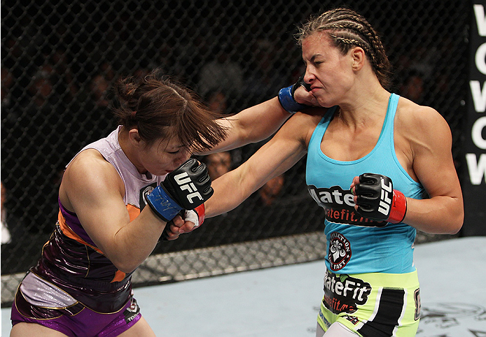 SAITAMA, JAPAN - SEPTEMBER 20: (L to R) Rin Nakai and Miesha Tate exchange punches in their bantamweight bout during the UFC Fight Night event inside the Saitama Arena on September 20, 2014 in Saitama, Japan. (Photo by Mitch Viquez/Zuffa LLC/Zuffa LLC vi