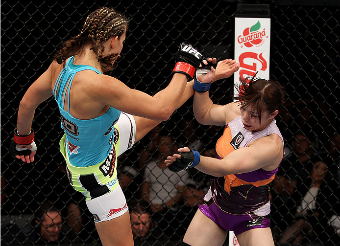 SAITAMA, JAPAN - SEPTEMBER 20: Miesha Tate throws a kick at Rin Nakai in their bantamweight bout during the UFC Fight Night event inside the Saitama Arena on September 20, 2014 in Saitama, Japan. (Photo by Mitch Viquez/Zuffa LLC/Zuffa LLC via Getty Images
