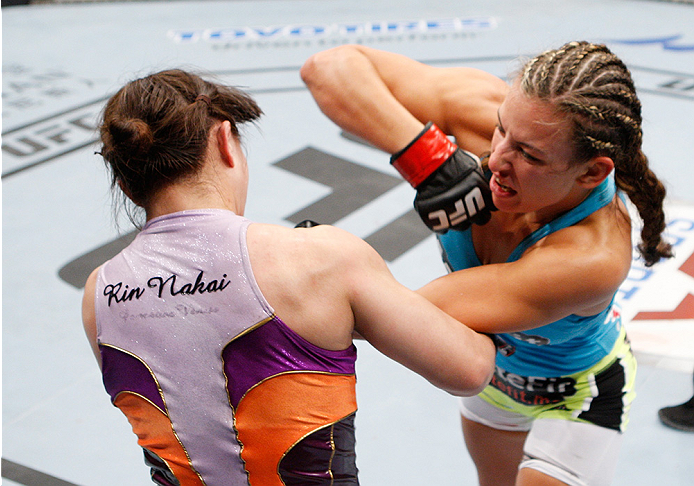 SAITAMA, JAPAN - SEPTEMBER 20: Miesha Tate throws an elbow at Rin Nakai in their bantamweight bout during the UFC Fight Night event inside the Saitama Arena on September 20, 2014 in Saitama, Japan. (Photo by Mitch Viquez/Zuffa LLC/Zuffa LLC via Getty Ima