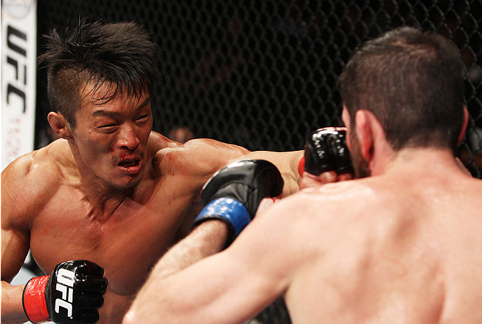 SAITAMA, JAPAN - SEPTEMBER 20: Yoshihiro Akiyama throws a punch at Amir Sadollah in their welterweight bout during the UFC Fight Night event inside the Saitama Arena on September 20, 2014 in Saitama, Japan. (Photo by Mitch Viquez/Zuffa LLC/Zuffa LLC via
