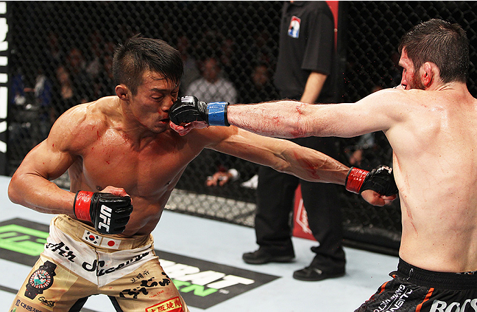 SAITAMA, JAPAN - SEPTEMBER 20: Amir Sadollah punched Yoshihiro Akiyama in their welterweight bout during the UFC Fight Night event inside the Saitama Arena on September 20, 2014 in Saitama, Japan. (Photo by Mitch Viquez/Zuffa LLC/Zuffa LLC via Getty Imag