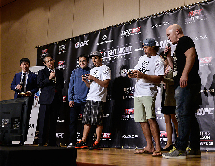 TOKYO, JAPAN - SEPTEMBER 17: Takeya Mizugaki and Urijah Faber (White T-Shirt) play the new EA UFC video game during the UFC Ultimate Media Day at the Hilton Tokyo on September 17, 2014 in Tokyo, Japan. (Photo by Keith Tsuji/Zuffa LLC/Zuffa LLC via Getty