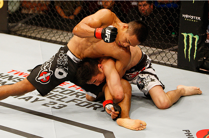 MANILA, PHILIPPINES - MAY 16: (L to R) Nolan Ticman of the United States and Yao Zhikui of China wrestle for position in their flyweight fight during the UFC Fight Night event at the Mall of Asia Arena on May 16, 2015 in Manila, Philippines. (Photo by Mit