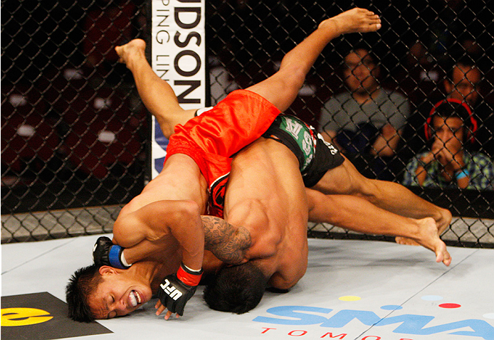 MANILA, PHILIPPINES - MAY 16: (L to R) Roldan Sangcha-An of the Philippines and Jon Delos Reyes of Guam wrestle for position in their flyweight fight during the UFC Fight Night event at the Mall of Asia Arena on May 16, 2015 in Manila, Philippines. (Pho
