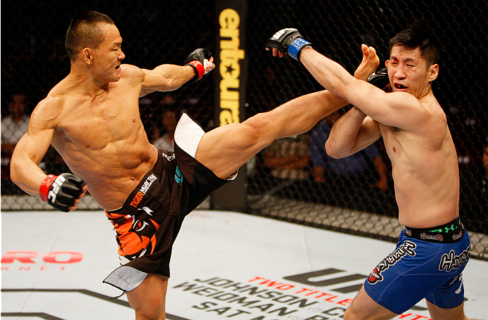 MANILA, PHILIPPINES - MAY 16: Ning Guangyou of China kicks Royston Wee of Singapore in their bantamweight fight during the UFC Fight Night event at the Mall of Asia Arena on May 16, 2015 in Manila, Philippines. (Photo by Mitch Viquez/Zuffa LLC/Zuffa LLC