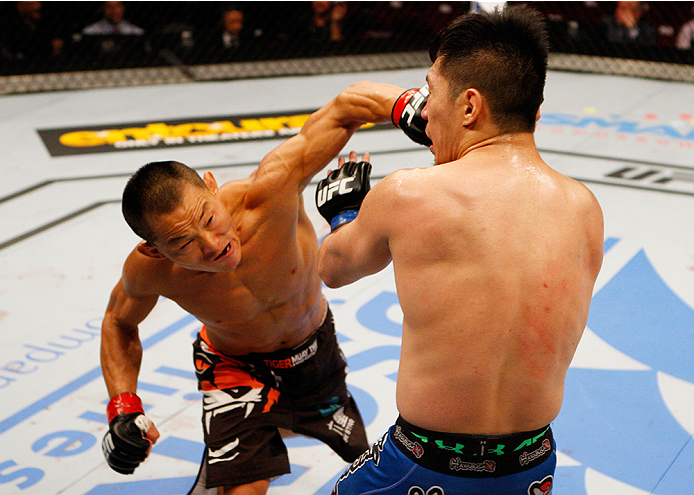 MANILA, PHILIPPINES - MAY 16: Ning Guangyou of China throws a punch at Royston Wee of Singapore in their bantamweight fight during the UFC Fight Night event at the Mall of Asia Arena on May 16, 2015 in Manila, Philippines. (Photo by Mitch Viquez/Zuffa LLC