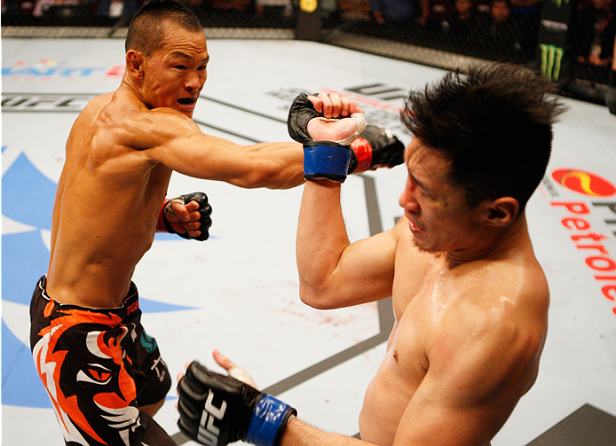 MANILA, PHILIPPINES - MAY 16: Ning Guangyou of China throws a punch at Royston Wee of Singapore in their bantamweight fight during the UFC Fight Night event at the Mall of Asia Arena on May 16, 2015 in Manila, Philippines. (Photo by Mitch Viquez/Zuffa LLC