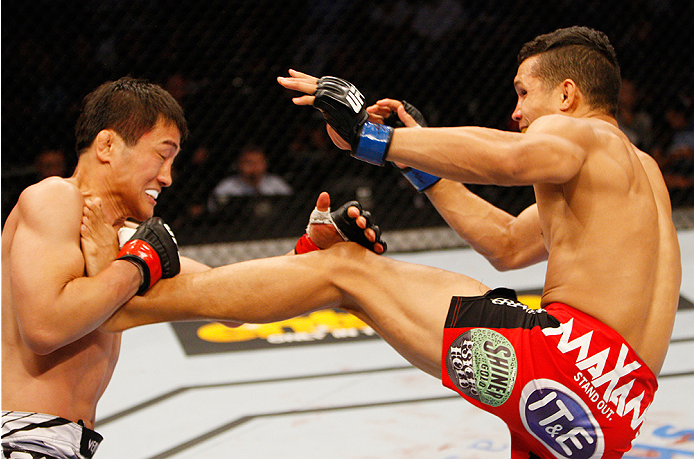 MANILA, PHILIPPINES - MAY 16: Tae Hyun Bang of South Korea goes catches the kick of Jon Tuck of Guam in their lightweight fight during the UFC Fight Night event at the Mall of Asia Arena on May 16, 2015 in Manila, Philippines. (Photo by Mitch Viquez/Zuffa