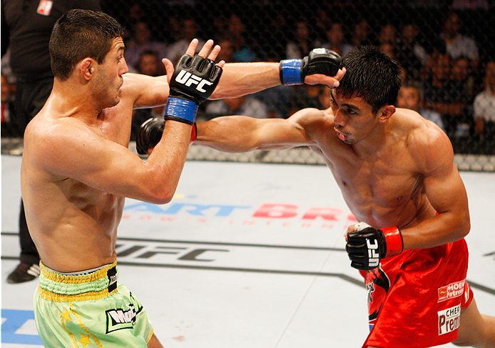 MANILA, PHILIPPINES - MAY 16: (L to R) Levan Makashvili of the United States and Mark Eddiva of the Philippines exchange punches in their featherweight fight during the UFC Fight Night event at the Mall of Asia Arena on May 16, 2015 in Manila, Philippine