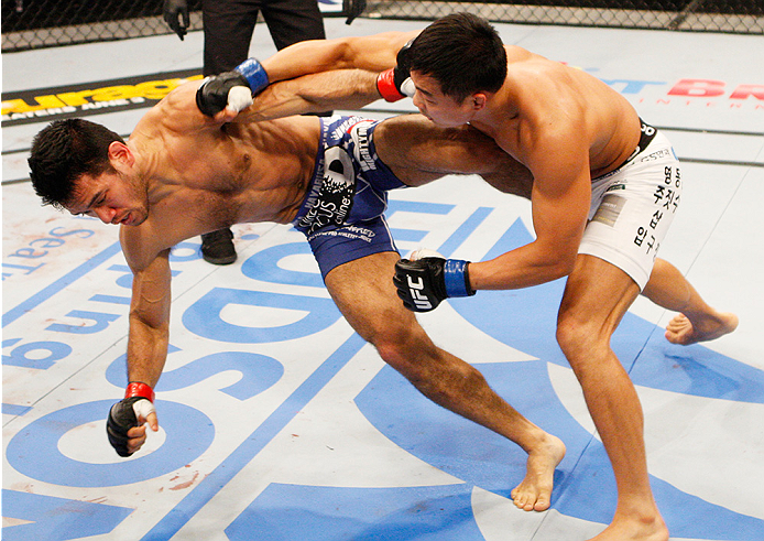 MANILA, PHILIPPINES - MAY 16: Yui Chul Nam of South Korea punches Phillipe Nover of the United States in their featherweight fight during the UFC Fight Night event at the Mall of Asia Arena on May 16, 2015 in Manila, Philippines. (Photo by Mitch Viquez/Z