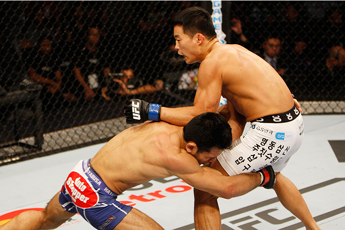 MANILA, PHILIPPINES - MAY 16: Phillipe Nover of the United States shoots for a takedown on Yui Chul Nam of South Korea in their featherweight fight during the UFC Fight Night event at the Mall of Asia Arena on May 16, 2015 in Manila, Philippines. (Photo