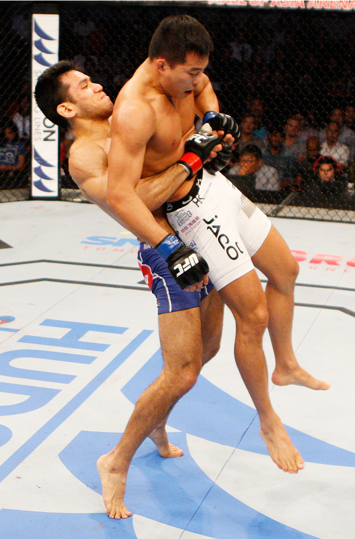 MANILA, PHILIPPINES - MAY 16: Phillipe Nover of the United States goes for a takedown on Yui Chul Nam of South Korea in their featherweight fight during the UFC Fight Night event at the Mall of Asia Arena on May 16, 2015 in Manila, Philippines. (Photo by