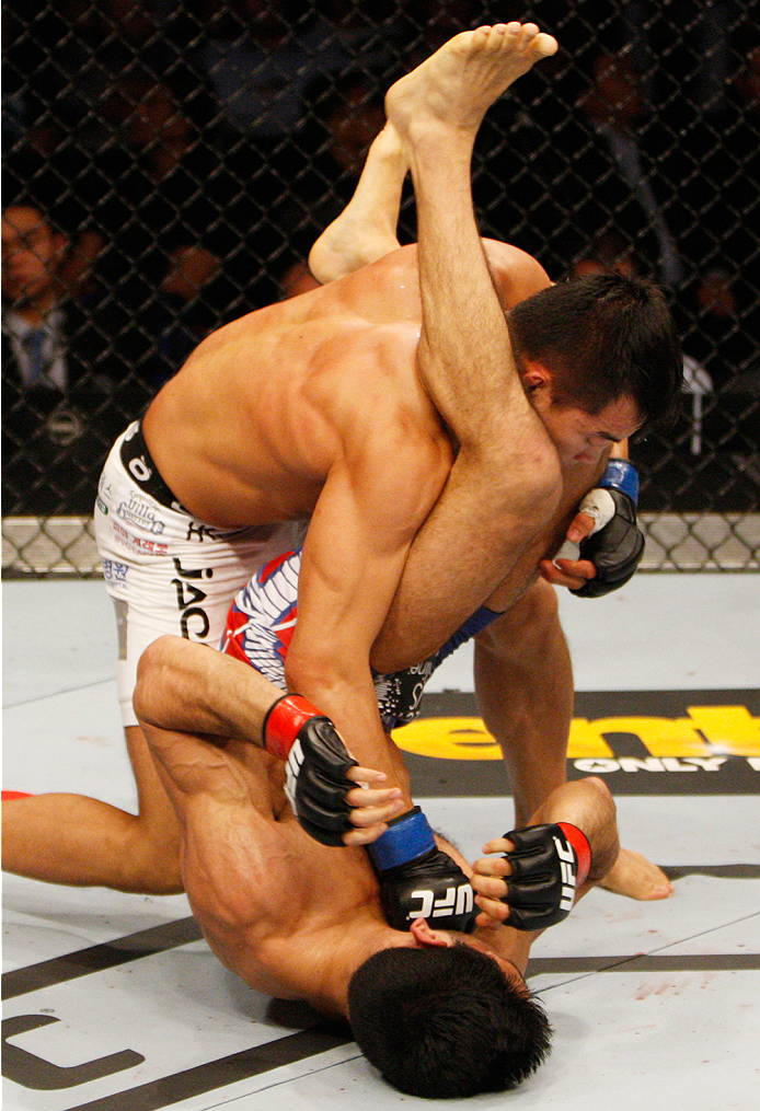 MANILA, PHILIPPINES - MAY 16: Yui Chul Nam of South Korea punches Phillipe Nover of the United States in their featherweight fight during the UFC Fight Night event at the Mall of Asia Arena on May 16, 2015 in Manila, Philippines. (Photo by Mitch Viquez/Zu