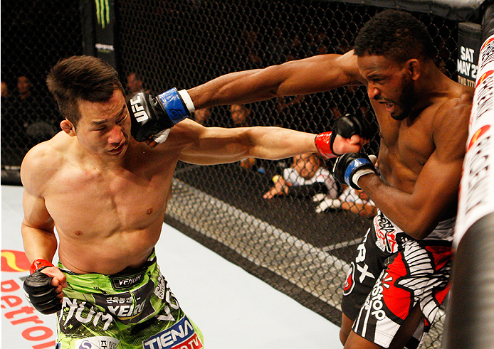 MANILA, PHILIPPINES - MAY 16: (L to R) Hyun Gyu Lim of South Korea and Neil Magny of the United States exchange punches in their welterweight fight during the UFC Fight Night event at the Mall of Asia Arena on May 16, 2015 in Manila, Philippines. (Photo