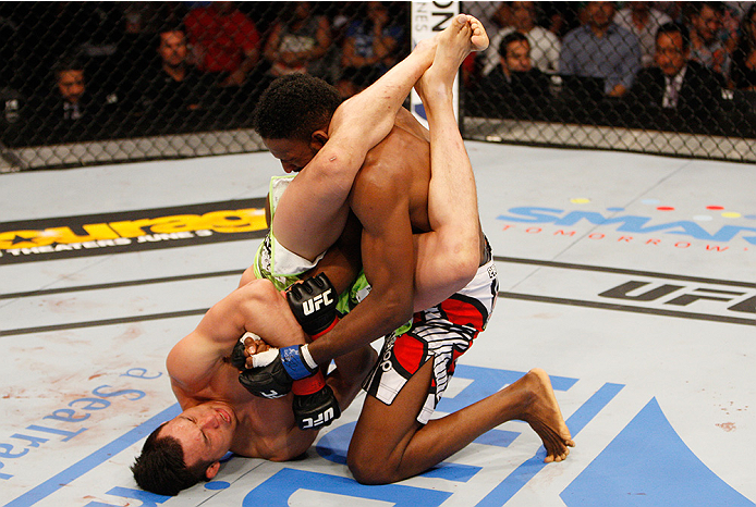 MANILA, PHILIPPINES - MAY 16: Hyun Gyu Lim of South Korea goes for a submission on Neil Magny of the United States in their welterweight fight during the UFC Fight Night event at the Mall of Asia Arena on May 16, 2015 in Manila, Philippines. (Photo by Mit