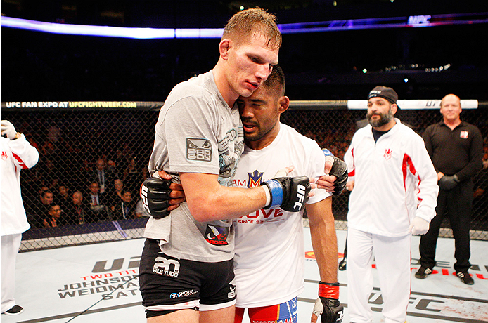 MANILA, PHILIPPINES - MAY 16: (L to R) Luke Barnatt of England and Mark Munoz of the United States embrace after their middleweight fight during the UFC Fight Night event at the Mall of Asia Arena on May 16, 2015 in Manila, Philippines. (Photo by Mitch Vi
