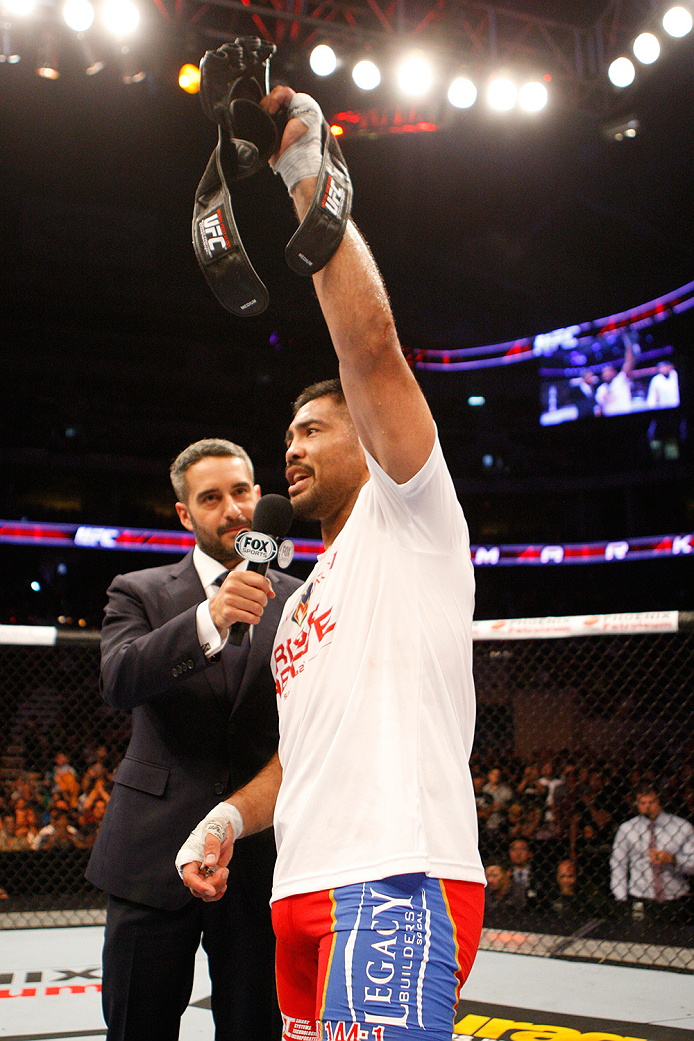 MANILA, PHILIPPINES - MAY 16: Jon Anik speaks to Mark Munoz of the United States after his win. Munoz retired from the UFC, leaving his gloves in the middle of the octagon during the UFC Fight Night event at the Mall of Asia Arena on May 16, 2015 in Manil